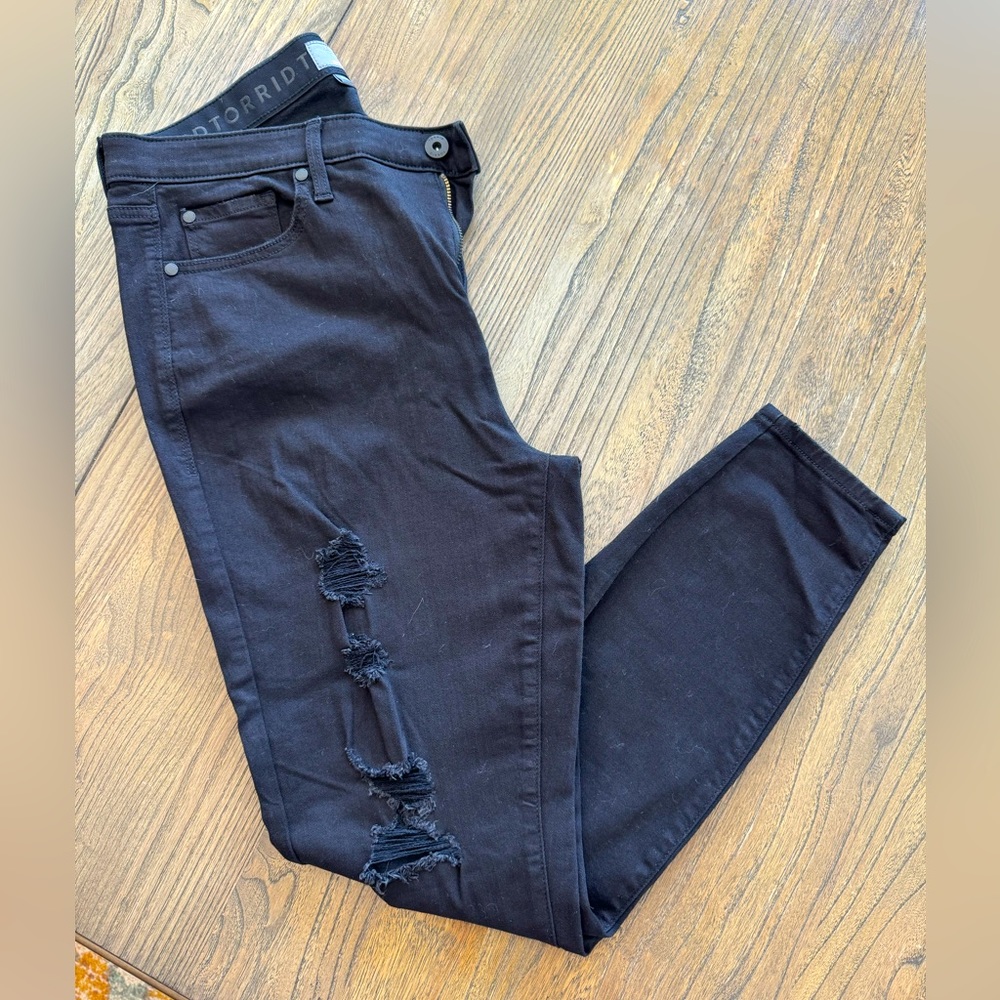 Torrid size 16R black skinny jeans with ripped legs.